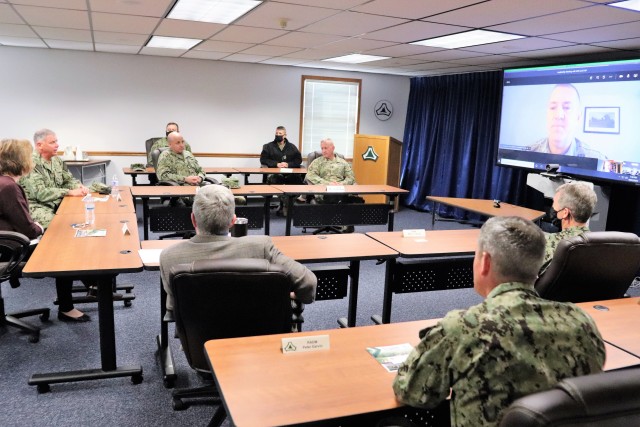 Assistant Secretary of the Navy (Manpower and Reserve Affairs) Catherine Kessmeier and Vice Adm. John Nowell, Jr., Chief of Naval Personnel (CNP), participate in a socially distanced meeting with Fort McCoy Deputy to the Garrison Commander Brad Stewart and Command Sgt. Maj. Paul Mantha, garrison command sergeant major, on Oct. 27, 2020, at the garrison headquarters building at Fort McCoy, Wis. Garrison Commander Col. Michael D. Poss dialed in virtually from a temporary duty location. The Navy leadership team visited Fort McCoy to meet with Navy cadre personnel who are working with new recruits at Fort McCoy before they attend boot camp at Recruit Training Command in Great Lakes, Ill. They stopped by to thank Fort McCoy staff for their continued support of this unique and critical Navy mission. Joining the assistant secretary and the CNP were Rear Adm. Peter Garvin, Commander of Naval Education and Training Command, Rear Adm. Jamie Sands, commander of Naval Service Training Command, and Master Chief Petty Officer of the Navy Russell Smith. (U.S. Army Photo by Scott T. Sturkol, Public Affairs Office, Fort McCoy, Wis.)