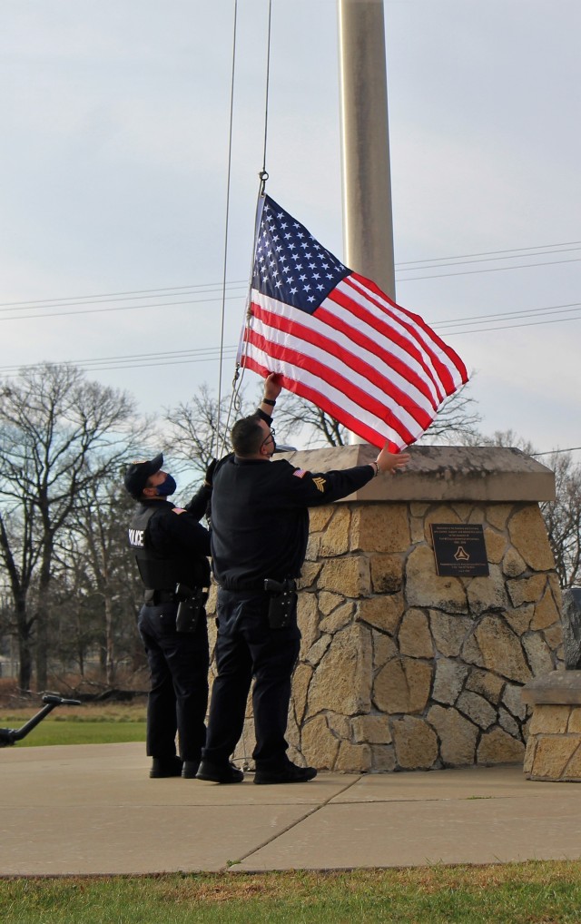 Officers with the Fort McCoy Directorate of Emergency Services Police Department raise the U.S. flag and the POW/MIA flag Nov. 12, 2020, at Fort McCoy, Wis. The team of officers replaced an older POW/MIA flag with a new one. The police regularly...