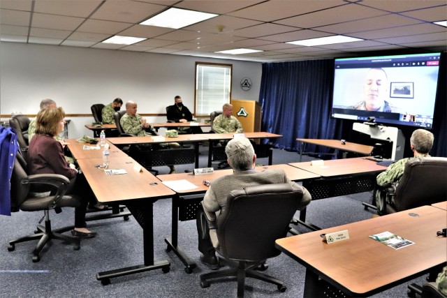 Assistant Secretary of the Navy (Manpower and Reserve Affairs) Catherine Kessmeier and Vice Adm. John Nowell, Jr., Chief of Naval Personnel (CNP), participate in a socially distanced meeting with Fort McCoy Deputy to the Garrison Commander Brad Stewart and Command Sgt. Maj. Paul Mantha, garrison command sergeant major, on Oct. 27, 2020, at the garrison headquarters building at Fort McCoy, Wis. Garrison Commander Col. Michael D. Poss dialed in virtually from a temporary duty location. The Navy leadership team visited Fort McCoy to meet with Navy cadre personnel who are working with new recruits at Fort McCoy before they attend boot camp at Recruit Training Command in Great Lakes, Ill. They stopped by to thank Fort McCoy staff for their continued support of this unique and critical Navy mission. Joining the assistant secretary and the CNP were Rear Adm. Peter Garvin, Commander of Naval Education and Training Command, Rear Adm. Jamie Sands, commander of Naval Service Training Command, and Master Chief Petty Offi