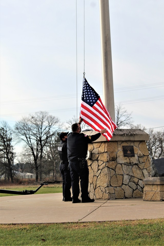 Officers with the Fort McCoy Directorate of Emergency Services Police Department raise the U.S. flag and the POW/MIA flag Nov. 12, 2020, at Fort McCoy, Wis. The team of officers replaced an older POW/MIA flag with a new one. The police regularly...