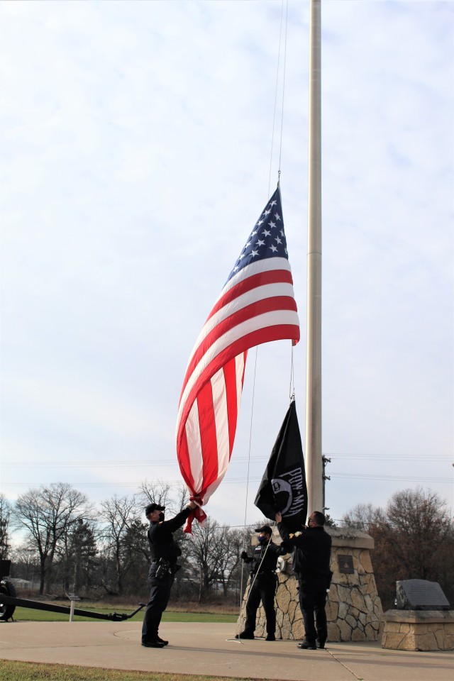 Officers with the Fort McCoy Directorate of Emergency Services Police Department raise the U.S. flag and the POW/MIA flag Nov. 12, 2020, at Fort McCoy, Wis. The team of officers replaced an older POW/MIA flag with a new one. The police regularly...
