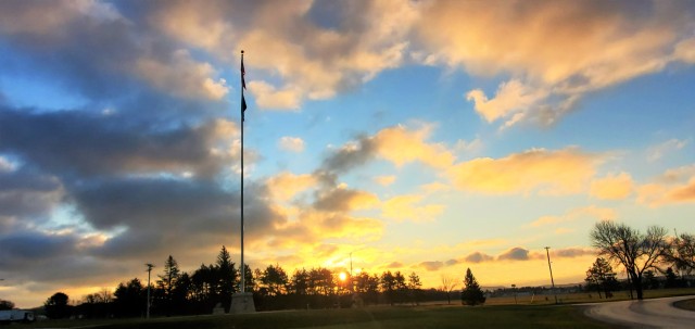 The U.S. flag is shown on the garrison flagpole on Veterans Day on Nov. 11, 2020, as the sun rises at Fort McCoy, Wis. In 1918, on the 11th hour of the 11th day of the 11th month, an armistice was declared between the Allied nations and Germany in World War I, history shows. More than 116,000 Americans died in World War I defending the lives and freedom of the United States’ European allies. The following year, President Woodrow Wilson proclaimed Nov. 11 as the first commemoration to honor the Soldiers who fought in that war, and the day was originally known as Armistice Day. Nov. 11 became a federal holiday in 1938, and in 1954 Congress decided to change the day to Veteran's Day. This was because they wanted to honor the veterans of all wars including World War II and the Korean War. (U.S. Army Photo by Scott T. Sturkol, Public Affairs Office, Fort McCoy, Wis.)