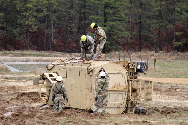 Soldiers at Fort McCoy, Wis., for training in the Regional Training Site-Maintenance Wheeled-Vehicle Recovery Operations Course work together during training Oct. 23, 2020, at the installation Vehicle Recovery Site on North Post. The 17-day course covers operation and maintenance of recovery vehicles and use of standard procedures to rig and recover wheeled vehicles. Related training tasks include oxygen and acetylene gas welding; boom and hoist operations; winch operations; and recovery of mired, overturned, and disabled vehicles. RTS-Maintenance holds several sessions of the Wheeled-Vehicle Operations Course each year and trains Soldiers from both active- and reserve-component forces. (U.S. Army Photo by Scott T. Sturkol, Public Affairs Office, Fort McCoy, Wis.)