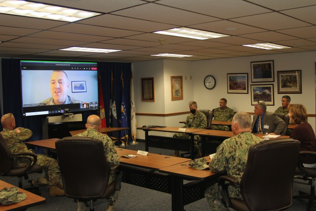 Assistant Secretary of the Navy (Manpower and Reserve Affairs) Catherine Kessmeier and Vice Adm. John Nowell, Jr., Chief of Naval Personnel (CNP), participate in a socially distanced meeting with Fort McCoy Deputy to the Garrison Commander Brad Stewart and Command Sgt. Maj. Paul Mantha, garrison command sergeant major, on Oct. 27, 2020, at the garrison headquarters building at Fort McCoy, Wis. Garrison Commander Col. Michael D. Poss dialed in virtually from a temporary duty location. The Navy leadership team visited Fort McCoy to meet with Navy cadre personnel who are working with new recruits at Fort McCoy before they attend boot camp at Recruit Training Command in Great Lakes, Ill. They stopped by to thank Fort McCoy staff for their continued support of this unique and critical Navy mission. Joining the assistant secretary and the CNP were Rear Adm. Peter Garvin, Commander of Naval Education and Training Command, Rear Adm. Jamie Sands, commander of Naval Service Training Command, and Master Chief Petty Officer of the Navy Russell Smith. (U.S. Army Photo by Kaleen Holliday, Public Affairs Office, Fort McCoy, Wis.)