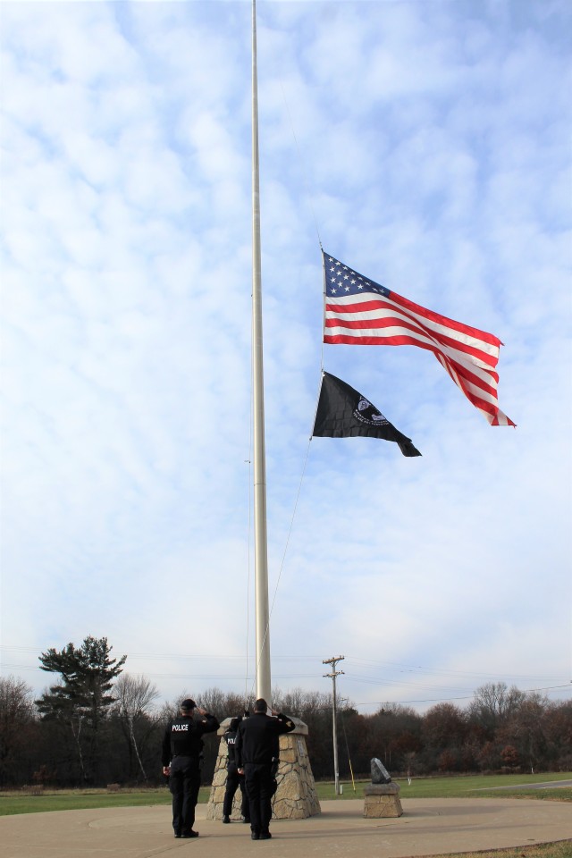 Officers with the Fort McCoy Directorate of Emergency Services Police Department raise the U.S. flag and the POW/MIA flag Nov. 12, 2020, at Fort McCoy, Wis. The team of officers replaced an older POW/MIA flag with a new one. The police regularly...