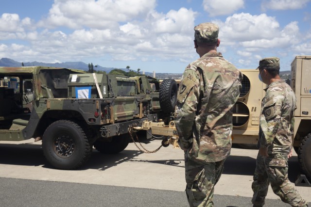 402nd Army Field Support Brigade commander Col. Anthony Walters visits the equipment staging area at Joint Base Pearl Harbor-Hickam with 402nd Army Field Support Battalion-Hawaii commander Lt. Col. Benjamin Kilgore.