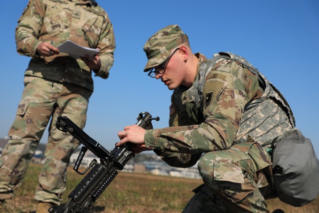 SAGAMIHARA, Japan – Sgt. Robert W. Redmond, military police, 14th Missile Defense Battery, reassembles a M249 light machine gun while being timed during the Pacific Guardian of the Quarter Competition at Sagami General Depot, Nov. 16. Eight Soldiers and noncommissioned officers assigned to various units throughout 38th Air Defense Artillery Brigade competed in a grueling test of their physical and mental abilities during a quarterly contest Nov. 16-17.