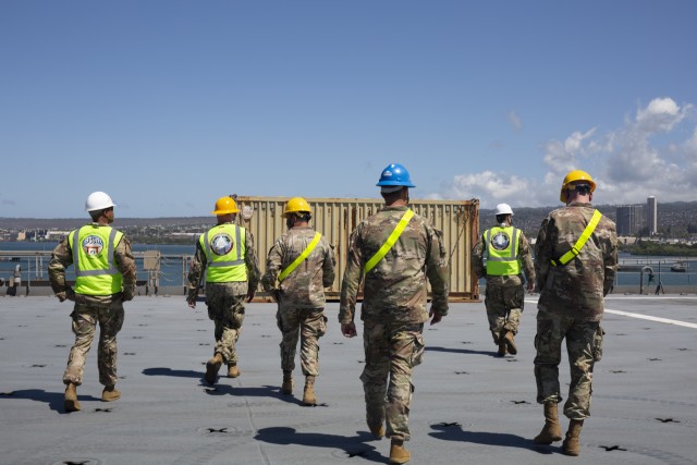 Leadership from the 402nd as well as the 599th Transportation Brigade tour the USNS Fisher as equipment for JRTC is loaded.