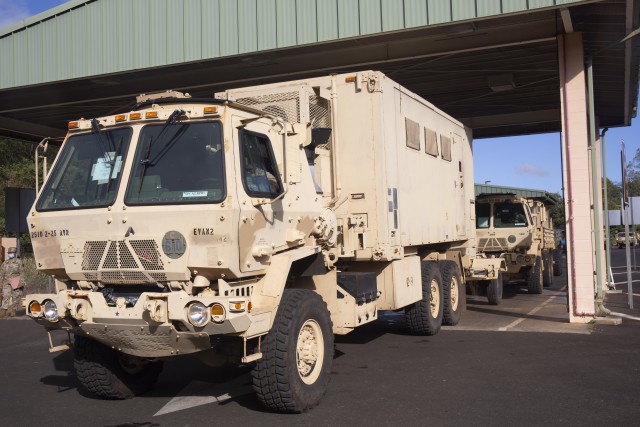 A vehicle moves from the weigh station to the maintenance inspection station during Multifunctional Deployment Facility operations. All vehicles, trailers and containers are processed through a five-step process before they can be transported to the port at Joint Base Pearl Harbor-Hickam to be loaded on the vessel.