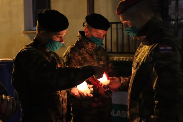 Croatian Soldiers light candles to honor their heroes on the even of Remembrance Day Nov. 17, 2020. Croatian Army Photo by Capt. Liviu Burtica