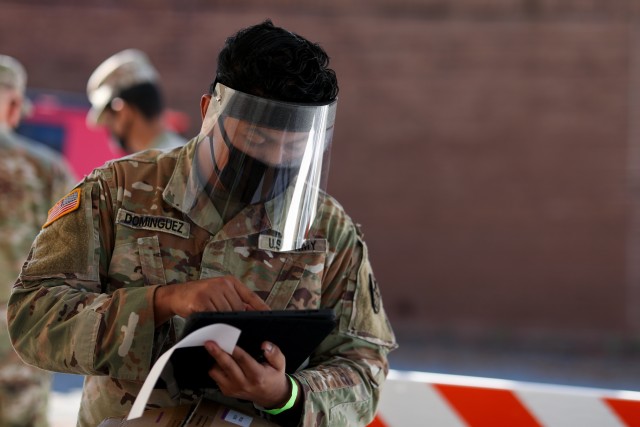 Pfc. Pedro Dominguez, assigned to the North Carolina Army National Guard’s 875th Engineer Company, enters a patient’s information at a drive-thru COVID-19 test site in High Point, N.C. on Nov. 13, 2020. More than 170 North Carolina National...
