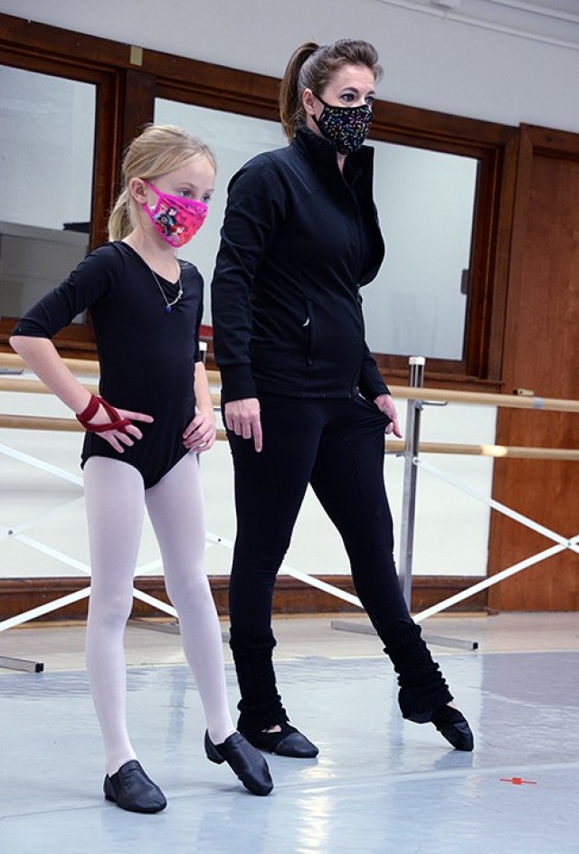 Dance instructor Holly Harmison helps 8-year-old Emily Bell perfect her form during the SKIES (Schools of Knowledge, Inspiration, Exploration and Skills) Unlimited tap-and-jazz combination dance class Nov. 12 at Patch Community Center. Other...