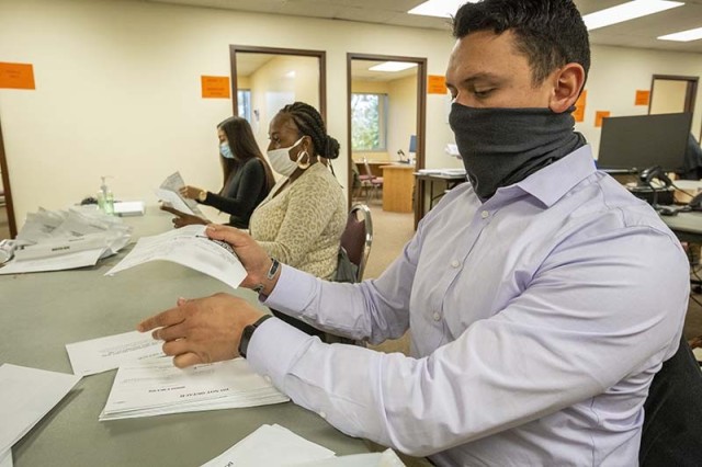 U.S. Air Force Senior Airman Matthew D. Talavera, right, Senior Airman Tashea S. Jackson-Medley, center, and Airman 1st Class Destiny J. Carl, all with the 177th Fighter Wing, New Jersey Air National Guard, processes ballots at the Board of...