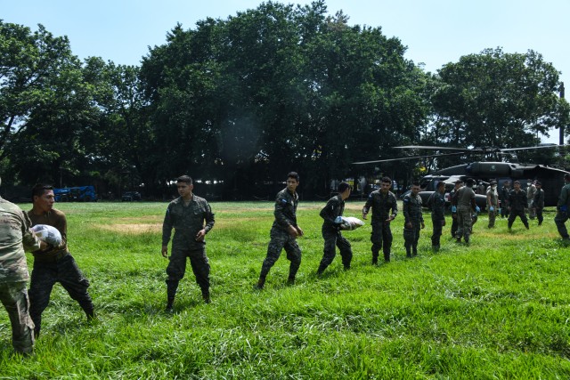Joint Task Force-Bravo members and Honduran soldiers load life-saving supplies on a U.S. Army HH-60 Black Hawk helicopter, assigned to the 1-228th Aviation Regiment, JTF-Bravo, for delivery to Urraco, Honduras at San Pedro Sula, Honduras, Nov. 11,...