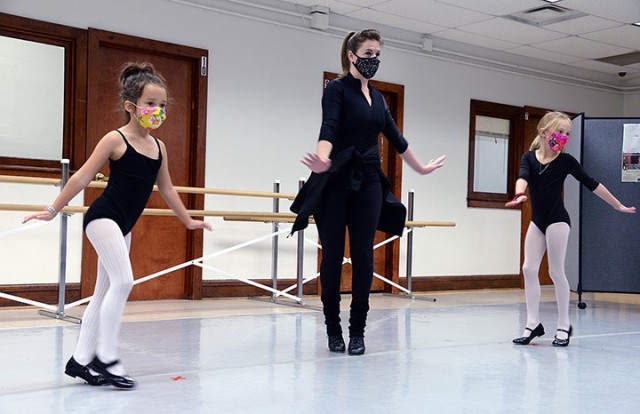 Seven-year-old Alice Phillips, dance instructor Holly Harmison and 8-year-old Emily Bell practice "sugar" dance steps as they move toward a mirror during the SKIES (Schools of Knowledge, Inspiration, Exploration and Skills) Unlimited tap-and-jazz...