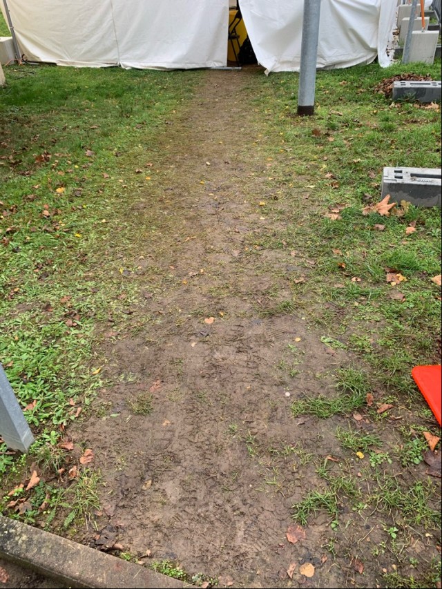 BEFORE: The path to the COVID testing center tent on Clay Kaserne was beginning to get muddy following foot traffic and rain. U.S. Army Garrison Wiesbaden and partners teamed up to provide a solution – heavy duty plastic pallets to keep patients...