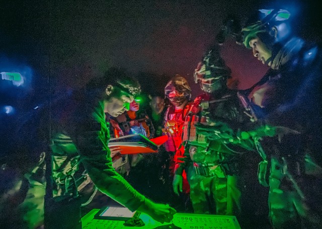 An aviation operations officer with the 25th Combat Aviation Brigade, 25th Infantry Division tracks flights with Royal Thai Army soldiers during night air assault as part of the Joint Forcible Entry exercise at the Joint Readiness Training Center at Fort Polk, Louisiana, Oct. 14, 2020. The JRTC exercise is a capstone training event that allows 2nd Brigade to achieve certification for worldwide deployment while building interoperability with key allies in support of a free and open Indo-Pacific. (U.S. Army photo by Sgt. Sarah D. Sangster)