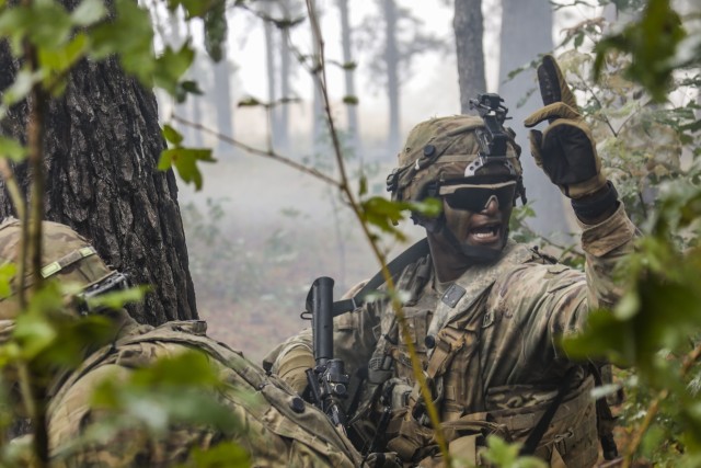 A combat engineer with 65th Brigade Engineer Battalion, 2nd Infantry Brigade Combat Team, 25th Infantry Division, motions his team toward the breach point during the final live fire exercise of rotation 21-01 on October 27th, 2020 at the Joint Readiness Training Center at Fort Polk, Lousiana. The JRTC exercise is a capstone training event that allows 2nd Brigade to achieve certification for worldwide deployment while building interoperability with key allies in support of a free and open Indo-Pacific. (U.S. Army photo by Sgt. Thomas Calvert)