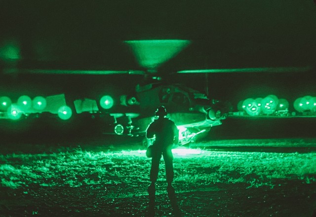 An AH-64 Apache pilot with the 25th Combat Aviation Brigade, 25th Infantry Division conducts pre-flight checks to lift off in support of an air assault exercise as part of force-on-force operations at the Joint Readiness Training Center at Fort Polk, Louisiana, Oct. 14, 2020. The JRTC exercise is a capstone training event that allows 2nd Brigade, 25th Infantry Division to achieve certification for worldwide deployment while building interoperability with key allies in support of a free and open Indo-Pacific. (U.S. Army photo by Sgt. Sarah D. Sangster)