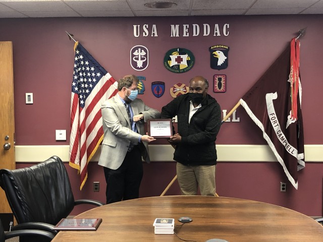 Dudley Wagner, Donor Resources and Development district manager for the American Red Cross Tennessee Valley Region, taps elbows with Leon Burgess, Transfusion Services and Immunology supervisor for Blanchfield Army Community Hospital, during a...