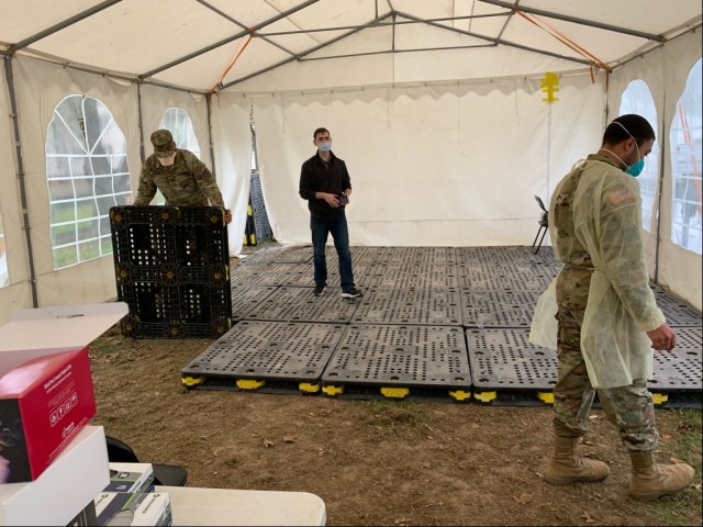 BEFORE: The inside of the COVID testing center tent on Clay Kaserne was beginning to get muddy following foot traffic and rain. U.S. Army Garrison Wiesbaden and partners teamed up to provide a solution – heavy duty plastic pallets to keep...