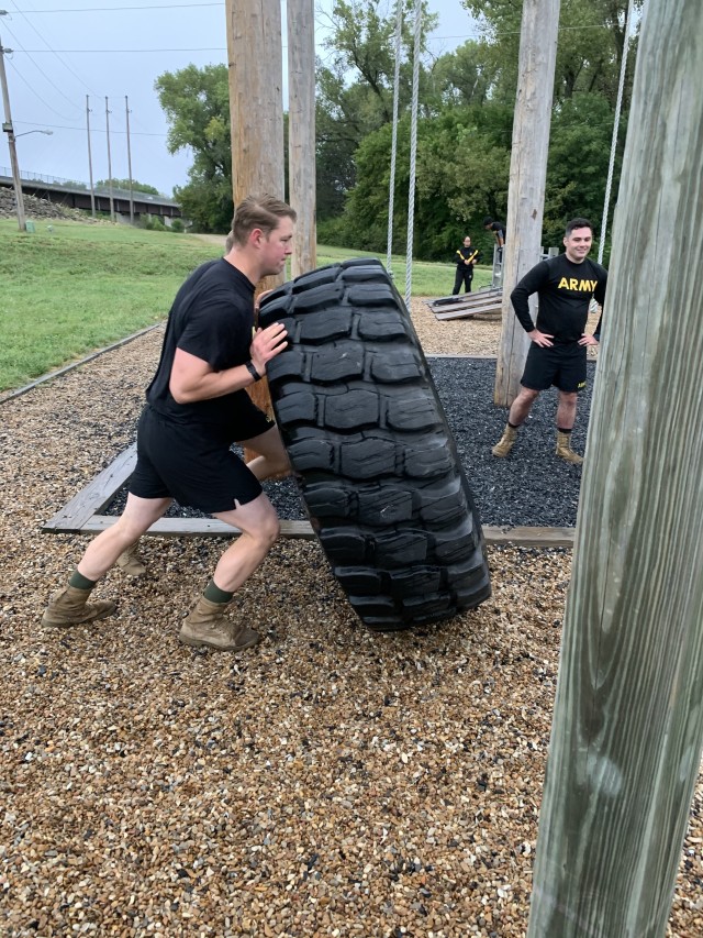 Capt. Joel D. Wetleson and Capt. Donald G. Perry of the 79th Explosive Ordnance Battalion (EOD), Fort Riley, Kan., flip a tire during the 79th EOD 9/11 Memorial Ruck and Team Building physical fitness training session Sept. 11, 2020, while Maj. Blake C. Zenteno looks on. Mixing the types and intensity of exercises to keep muscles challenged is one of the updated P3 Soldier Athlete targets.