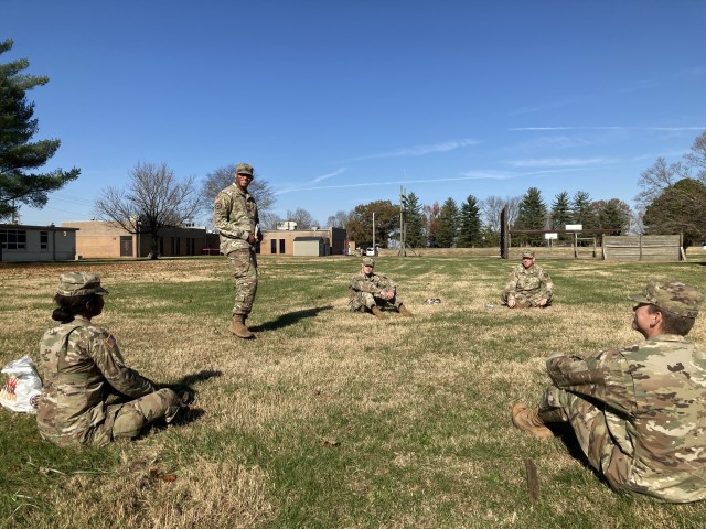 Staff Sergeant Anthony Bracy, standing, talks to Pfc. Verneige Jones, left, and other Soldiers of B Co., 39th Brigade Engineer Battalion, 2nd Brigade Combat Team, 101st Airborne Division (Air Assault), Nov. 13, as part of the first Eagle Day at Fort Campbell.