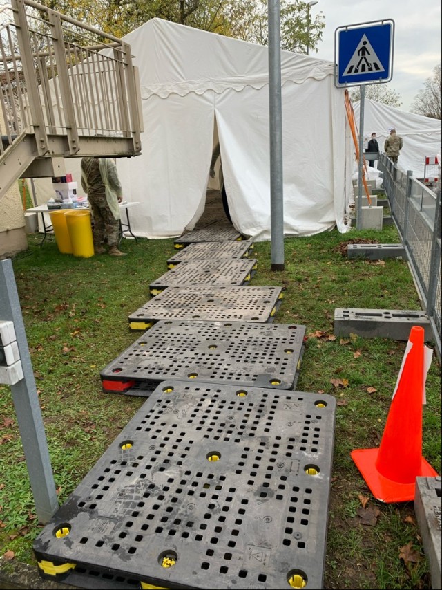 AFTER: The path to the COVID testing center tent on Clay Kaserne is now lined with heavy duty plastic pallets that will keep patients out of the mud.