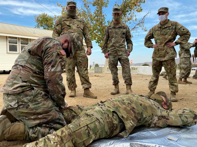 Sgt. 1st Class Oscar Sanchez, a platoon sergeant with Alpha Company, 1st Assault Helicopter Battalion, 140th Aviation Regiment, 40th Combat Aviation Brigade, applies a tourniquet on a simulated casualty during a Tactical Combat Casualty Care class at Camp Roberts on Nov. 3, 2020, during annual training. (U.S. Army National Guard photos by Sgt. 1st Class Ryan Sheldon)