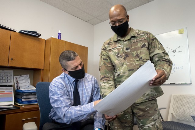 Chief of Supply, Production and Distribution Paul Ostrowski and U.S. Air Force Lt. Col. Nest Cage review plans at Operation Warp Speed headquarters in Washington, D.C. Nov. 13, 2020. Operation Warp Speed is an effort by several U.S. government...