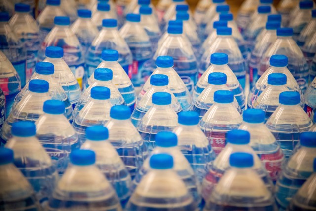 CAMP HUMPHREYS, Republic of Korea - Bottles of water are lined up to be placed in welcome bags for incoming single and unaccompanied Soldiers entering the quarantine process, during a Bag Brigade Drive at Freedom Chapel here, Nov. 21.  Volunteers...