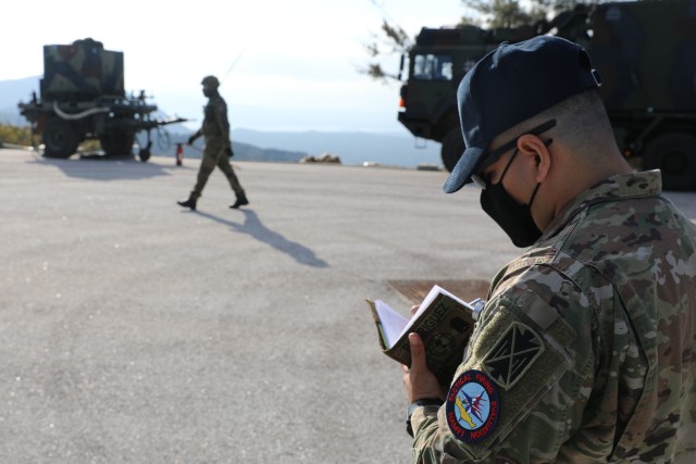 U.S. Army Sfc. Pablo Rodriguez, a patriot missile operator assigned to the 10th Army Air and Missile Defense Command and an evaluator for NAMFI 20, observes German airmen here on Nov. 17, 2020 at the NATO Missile Firing Installation(NAMFI). NAMFI...