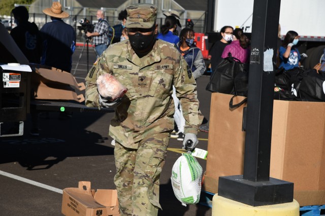 Arizona National Guard service members join local food banks and Chandler High School students to provide groceries such as turkeys, hams and vegetables for Thanksgiving dinner to area residents of Chandler, Ariz., Nov. 14, 2020. The Arizona...