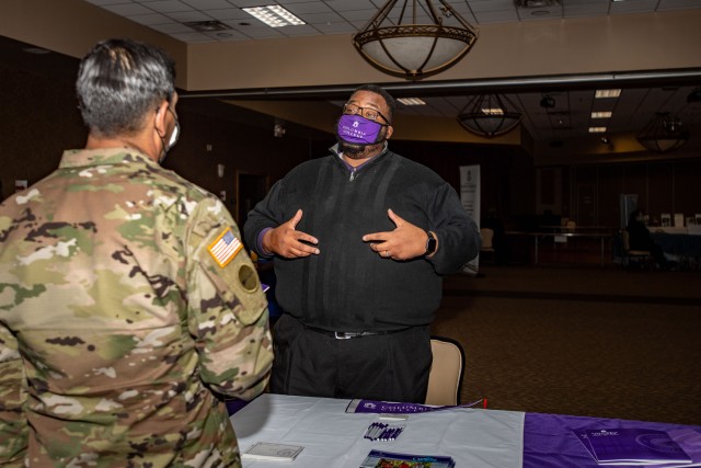 A representative from Columbia College speaks with a Soldier at the Fort Jackson Education Fair, Nov. 18. 