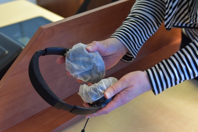 Korinna Inman, 86th Force Support Squadron formal training manager, holds a pair of headphones used at the testing center at Ramstein Air Base, Germany, Nov. 12, 2020. Inman is responsible for enforcing COVID-19 restrictions in the testing center....