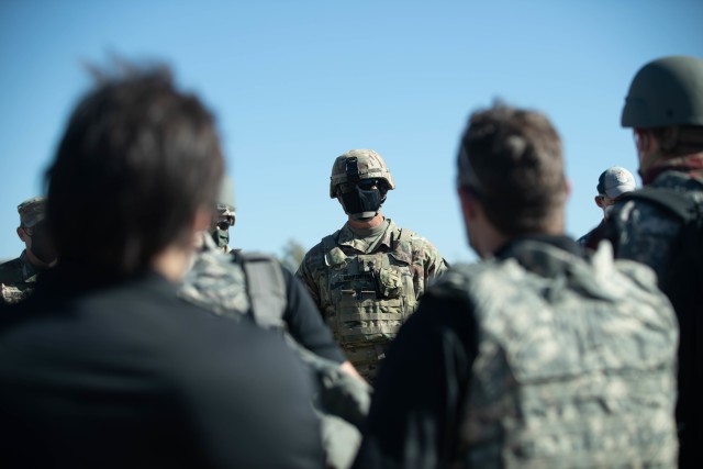 Lt. Col. Christopher Carpenter, Commander of 2nd Battalion, 82nd Field Artillery, 3rd Armored Brigade Combat Team, 1st Cavalry Division, speaks to a group of civilian agencies during a M109A7 Paladin life fire demonstration held by the field...