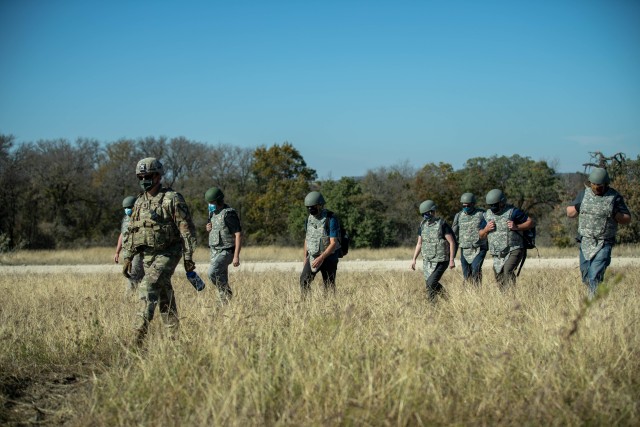 Capt. Stewart Tice, Commander of Bravo Battery, 2nd Battalion, 82nd Field Artillery, 3rd Armored Brigade Combat Team, 1st Cavalry Division, escorts a group of civilians to a firing line during a M109A7 Paladin life fire demonstration held by the...
