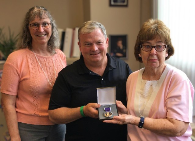 Bob Healy, recovery care coordinator at Fort Drum, and Theresa Neibacher, Jefferson State veteran service director, presented Suzanne Adderley with replacements for medals her late husband, Pfc. Charles Farney, was awarded during his service in...