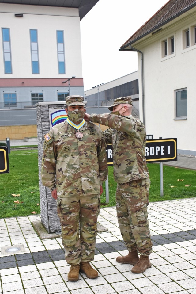 WIESBADEN, Germany – Master Sgt. Richard Brinkley, U.S. Army Garrison Wiesbaden provost sergeant, is presented with the Order of St. Maurice, Legionnaire, by Col. Howard Kirk, executive officer to the commanding general, U.S. Army Europe and...