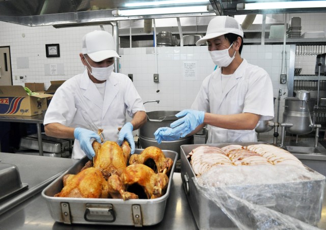 Makoto Arai, left, and Takafumi Fukumoto, cooks at the Camp Zama Dining Facility, prepare the traditional Thanksgiving luncheon at Camp Zama, Japan, Nov. 23.