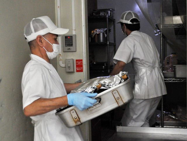Cooks at the Camp Zama Dining Facility, place food in the refrigerator as they prepare the traditional Thanksgiving luncheon at Camp Zama, Japan, Nov. 23.