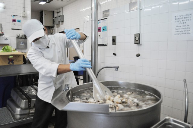 Takahiro Kaji, a cook at the Camp Zama Dining Facility, defrosts shrimp in preparation for the traditional Thanksgiving luncheon at Camp Zama, Japan, Nov. 23.