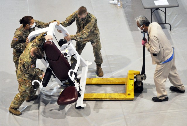 Soldiers and Camp Zama Family and Morale, Welfare and Recreation staff move gym equipment off the gym floor at the Yano Fitness Center at Camp Zama, Japan, Nov. 24. The installation used the gym for its annual Thanksgiving luncheon to have more...