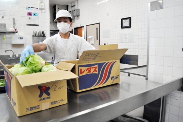 Takafumi Fukumoto, a cook at the Camp Zama Dining Facility, prepares lettuce for the traditional Thanksgiving luncheon at Camp Zama, Japan, Nov. 23.