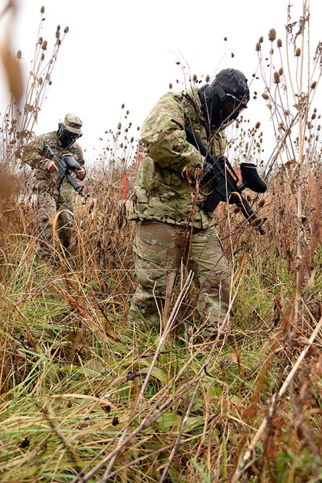 Staff Sgt. Roque Ortega and Spc. Gage Tomey enter the woods in search of the opposing force during Headquarters and Headquarters Company, Joint Regional Correctional Facility's Best Watchdog Competition Nov. 23 by the All-Hazards Training Center....