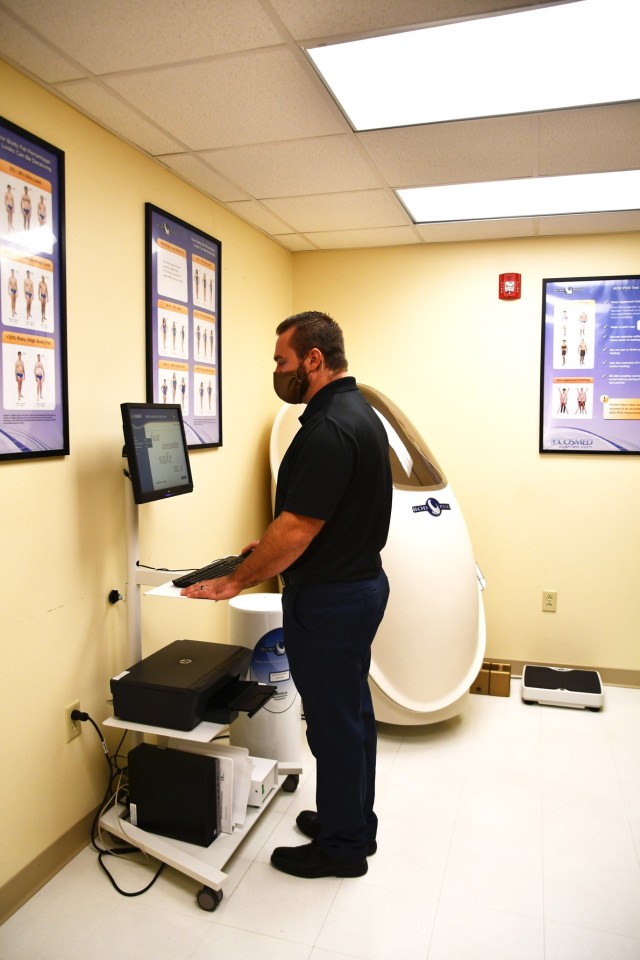 Eric Middleton, Fort Polk Army Wellness Center director, stands at the controls used to measure body elements when clients sit in the bod pod.