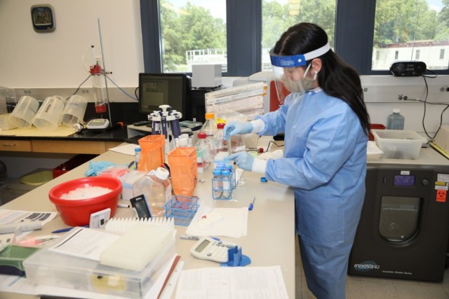 Letzibeth Mendez-Rivera, a lab manager with the Emerging Infectious Disease Branch at the Walter Reed Army Institute of Research, outside of Washington, D.C., studies coronavirus protein samples, June 1, 2020. The EIDB is part of WRAIR&#39;s effort to produce a COVID-19 vaccine candidate.