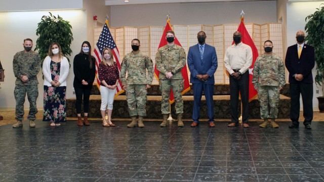 Half of the honorees stand together at Volunteer Appreciation Night Nov. 19, 2020, at the Patriot Club on Fort Sill, Oklahoma. From left, Marine Staff Sgt. Adam Fairchild, Shauna Gerritsen, Leslie Arajuo, Kylie Cardinet, presenter Col. Rich...
