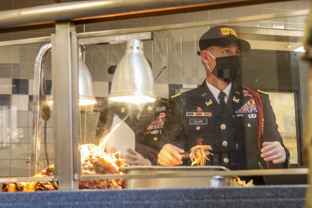 U.S. Army Lt. Col. Walter Allard, battalion commander, 326 Brigade Engineer Battalion, 1st Brigade Combat Team "Bastogne", 101st Airborne Division (Air Assault), prepares to serve turkey to Soldiers and Families within Snipes Dining Facility Nov....