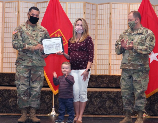 Kylie Cardinet receives a certificate of appreciation from Col. Rich Harrison, ADA School commandant and chief of ADA, during Volunteer Appreciation Night Nov. 19, 2020, at the Patriot Club. She volunteers as a Soldier and Family Readiness Group...